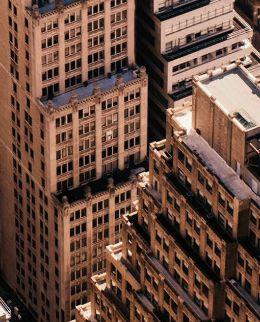 Best innovation in AI for operational automation and industry intelligence by Datos Insights Image of New York City buildings in gold tone