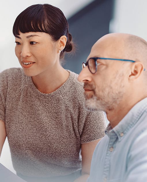 How AI-enabled BPaaS supports banking operations Two colleagues working together at a computer